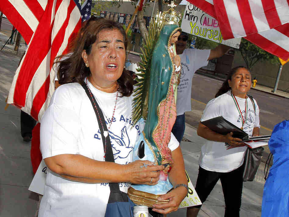 Rosa Maria Soto protests Maricopa County Sheriff Joe Arpaio outside the federal courthouse on July 19 in Phoenix. It was the first day of a trial that accuses Arpaio's office of racially profiling Latinos.
