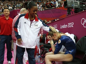 After Thursday's competition, American Gabby Douglas consoles silver medalist Victoria Komova of Russia.