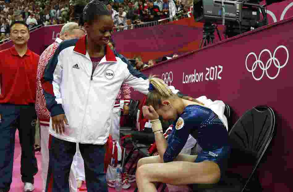 After Thursday's competition, American Gabby Douglas consoles silver medalist Victoria Komova of Russia.
