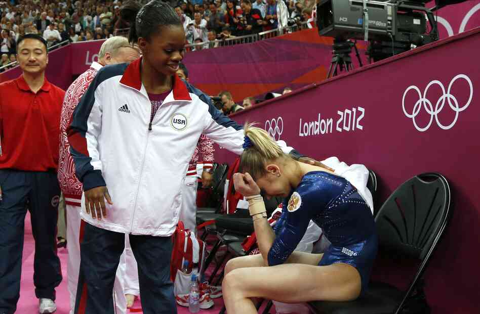 After Thursday's competition, American Gabby Douglas consoles silver medalist Victoria Komova of Russia.