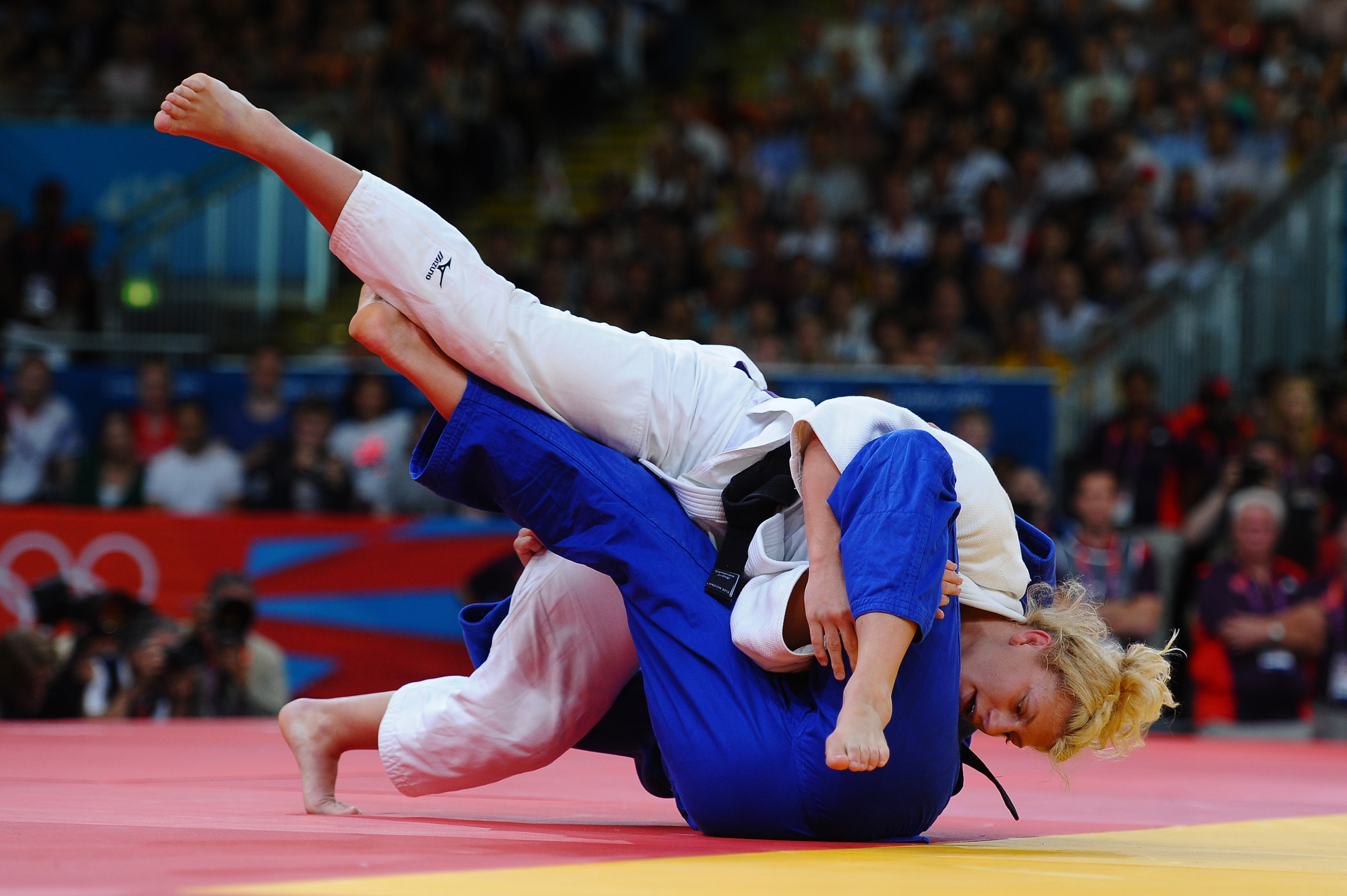 Kayla Harrison of the United States (in white) and Gemma Gibbons of Great Britain compete in the women's 78 kg judo.