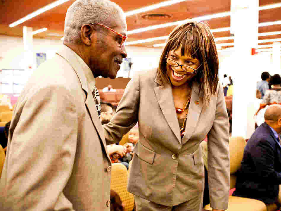 Natasha Shamone-Gilmore smiles at her father Franklin Brunson, 81, during a Sunday church service in Capitol Heights, Md. She has taken on the daily challenge of caring for her father, who is suffering from mild dementia.