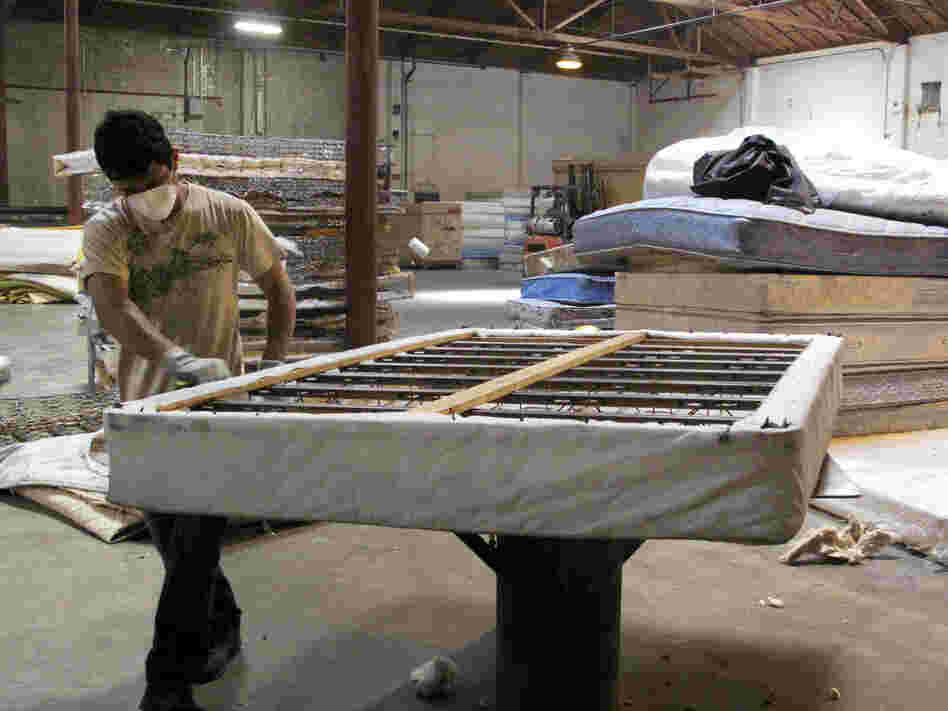 A worker dismantles a mattress at a recycling facility in Oakland, Calif. The material will be used to make carpet products and proceeds will help support the St. Vincent de Paul Society of Lane County, a nonprofit that helps low-income families in Eugene, Ore.