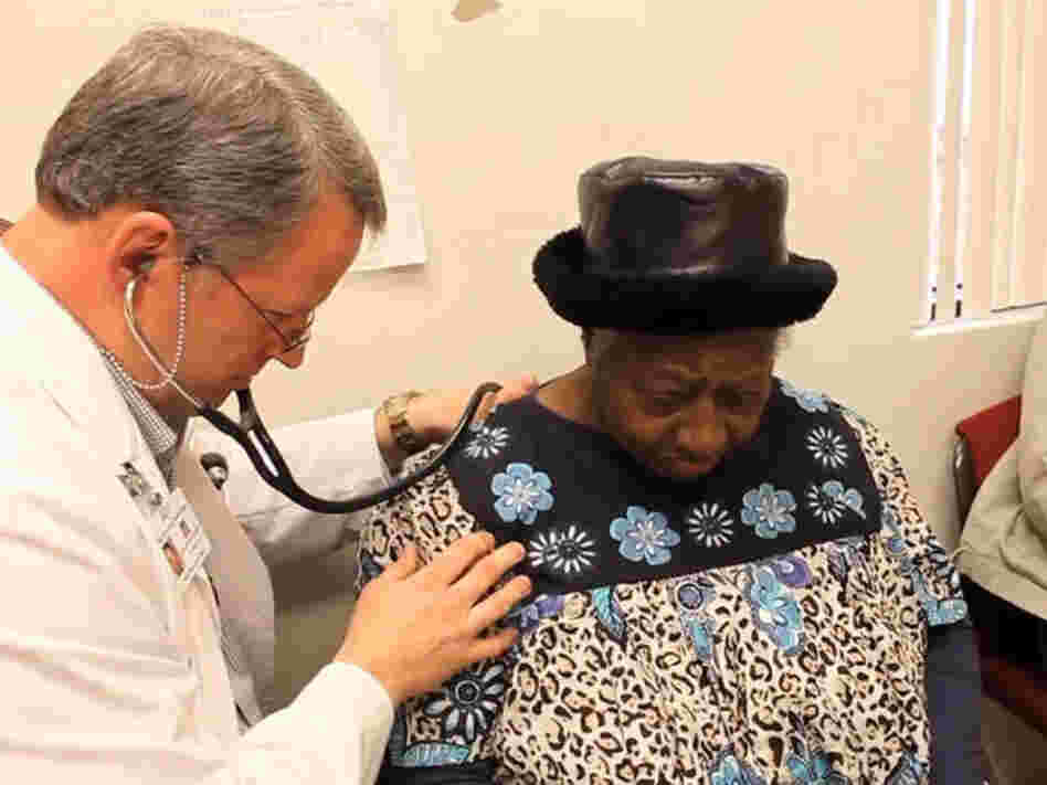 Dr. David Gilder gives Sally Johnson a checkup at the Mallory Community Health Center in Tchula, Miss.