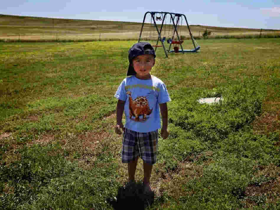 Derrin Yellow Robe, 3, stands in his great-grandparents' back yard on the Crow Creek Reservation in South Dakota. Along with his twin sister and two older sisters, he was taken off the reservation by South Dakota's Department of Social Services in July of 2009 and spent a year and a half in foster care before being returned to his family.