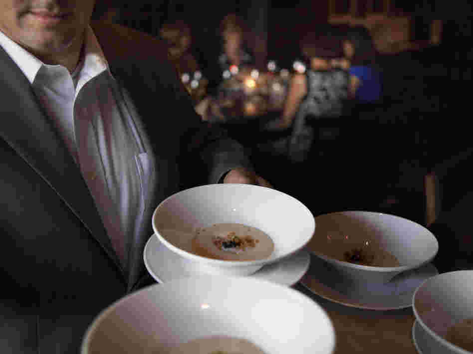 A server at Ardeo+Bardeo shows off potato mousse with a coddled egg hidden inside.