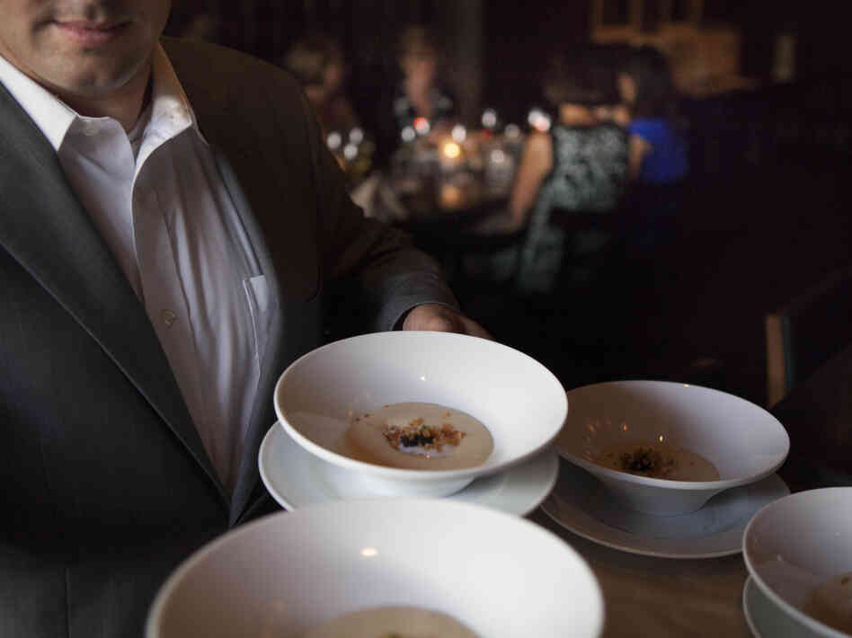 A server at Ardeo+Bardeo shows off potato mousse with a coddled egg hidden inside.