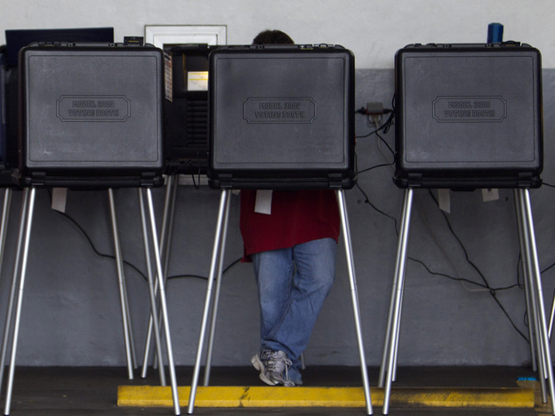 A voter casts his ballot in a West Miami, Fla., fire station during the Republican primary in January.