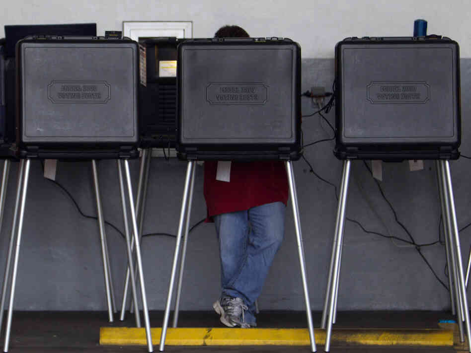 A voter casts his ballot in a West Miami, Fla., fire station during the Republican primary in January.