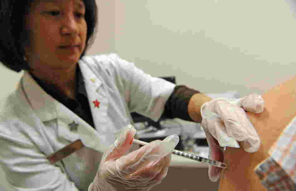 Pharmacist Kristy Hennessee administers a vaccination against whooping cough in Pasadena, Calif., in 2010. Vaccinations are the most powerful weapon for slowing the epidemic, but there are growing concerns that the current vaccine doesn't last as long as expected.