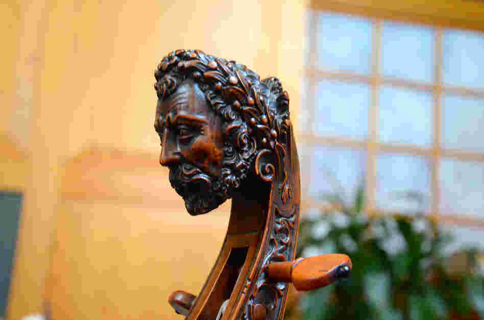A traditional carved head on an original, early 18th-century bass viol.