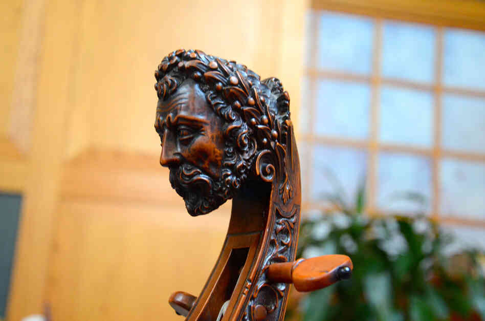 A traditional carved head on an original, early 18th-century bass viol.