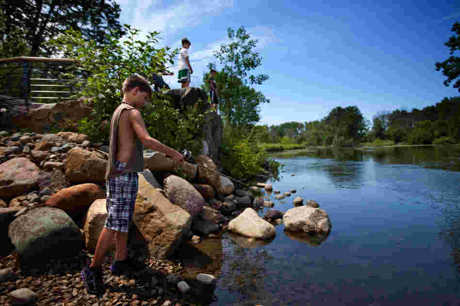 Children fish at a newly opened recreational area built by Enbridge on the Kalamazoo River. Posted signs warn that most of the fish is not safe to eat. These children were not aware of the oil spill and were not area residents.