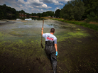 Whistle-blower John Bolenbaugh wades through thick mud in the Kalamazoo River looking for leftover traces of oil from the July 2010 Enbridge oil sands pipeline spill. Whistle-blower John Bolenbaugh wades through thick mud in the Kalamazoo River looking for leftover traces of oil from the July 2010 Enbridge oil sands pipeline spill.