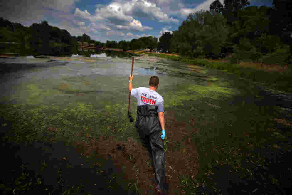 Whistle-blower John Bolenbaugh wades through thick mud in the Kalamazoo River looking for leftover traces of oil from the July 2010 Enbridge tar sands pipeline spill.