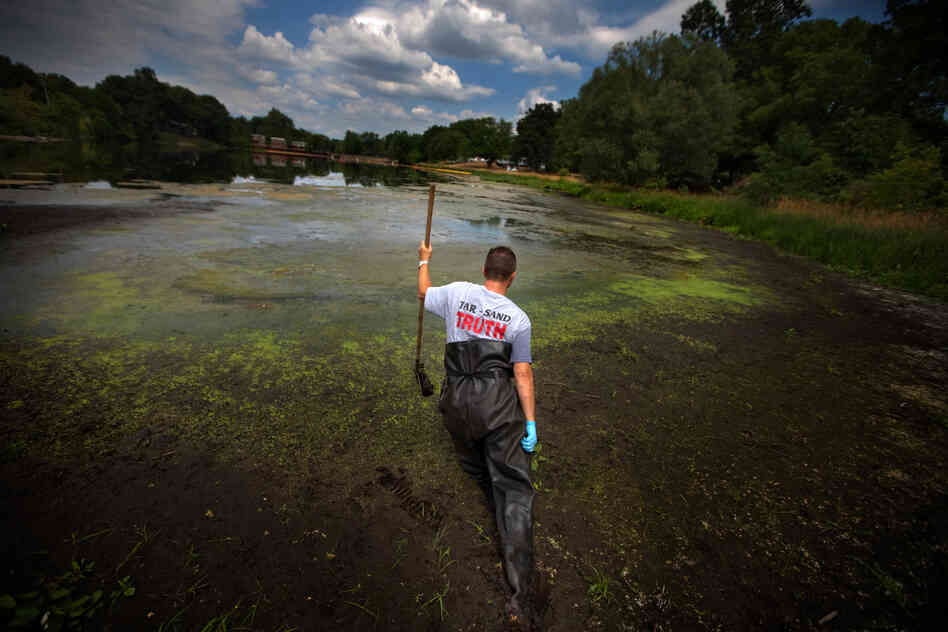 Whistle-blower John Bolenbaugh wades through thick mud in the Kalamazoo River looking for leftover traces of oil from the July 2010 Enbridge tar sands pipeline spill.