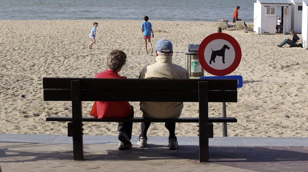 People enjoy a sunny day on the beach in Knokke, on Belgium's North Sea coast, in  April 2011. This summer, the weather hasn't been as nice — and resort owners and officials are feeling litigious over a pessimistic weather forecast.