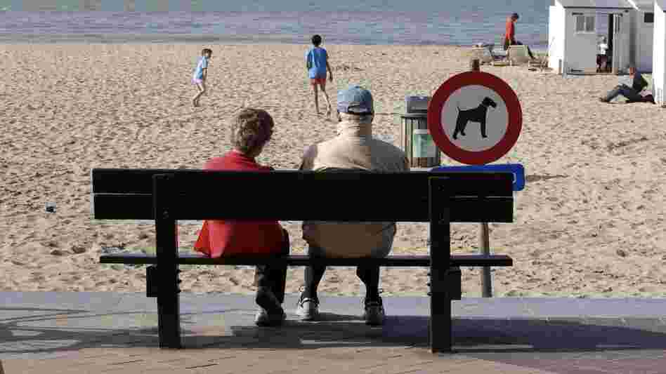 People enjoy a sunny day on the beach in Knokke, on Belgium's North Sea coast, in  April 2011. This summer, the weather hasn't been as nice — and resort owners and officials are feeling litigious over a pessimistic weather forecast.