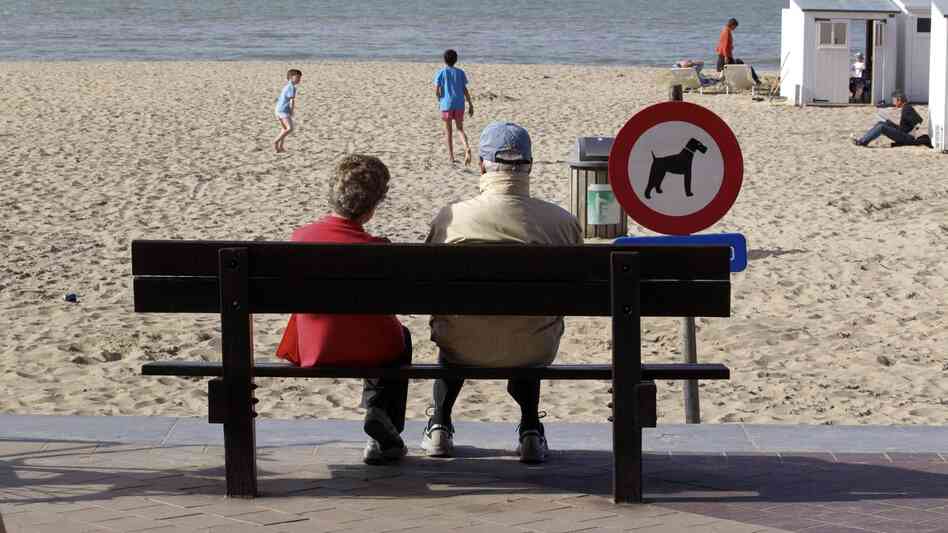 People enjoy a sunny day on the beach in Knokke, on Belgium's North Sea coast, in  April 2011. This summer, the weather hasn't been as nice — and resort owners and officials are feeling litigious over a pessimistic weather forecast.