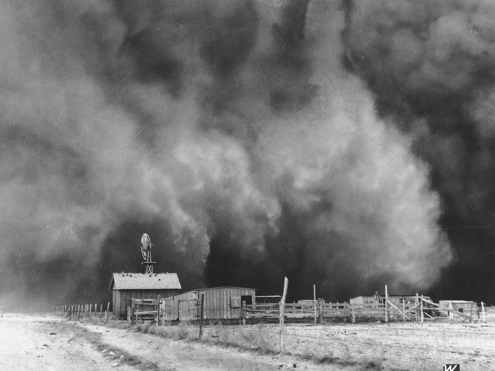 A gigantic dust cloud engulfs a ranch in Boise City, Okla., in 1935.