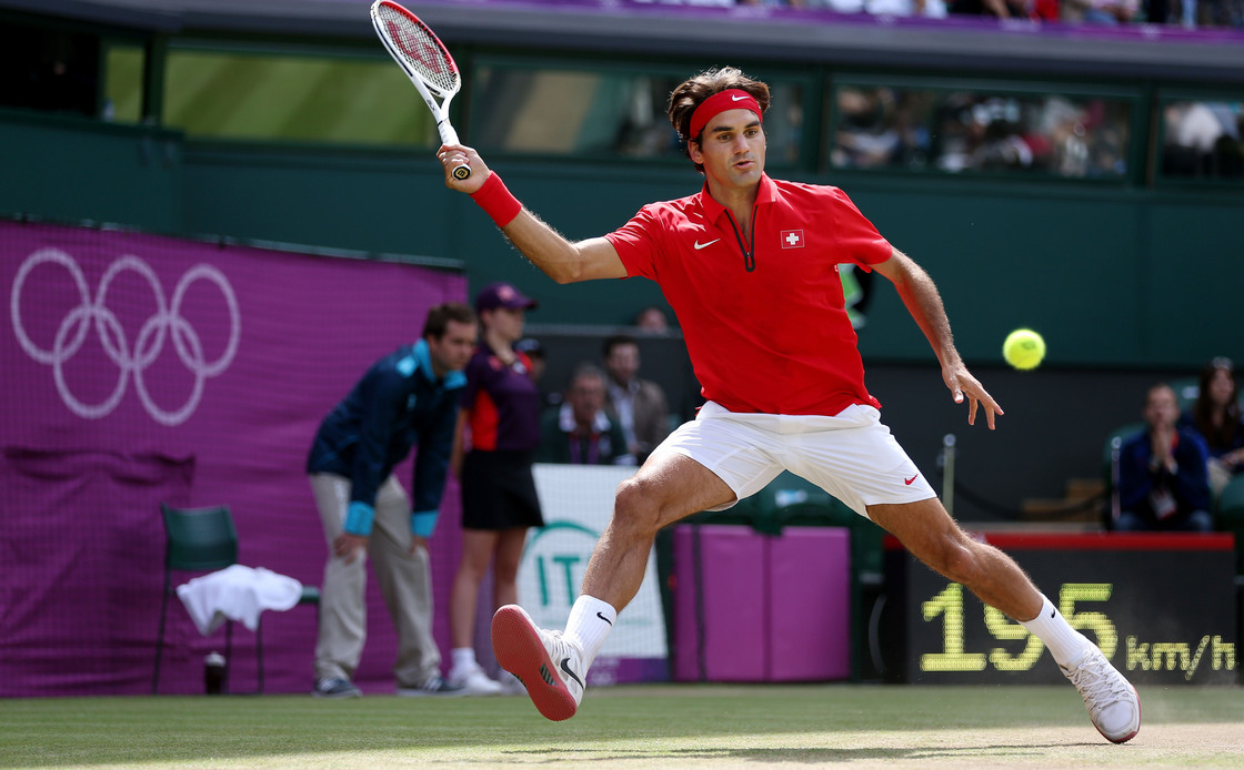 Roger Federer of Switzerland returns a shot against Juan Martin Del Potro of Argentina in their Olympic semifinal played at Wimbledon. Federer won the match, which took more than 4 hours to play.