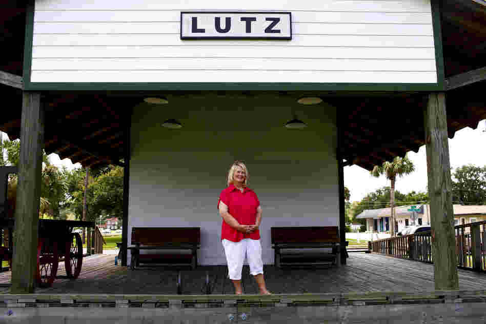 Faces of Florida's First and Main: Susan MacManus lives in her family's home on a secluded plot of land near Lutz, Fla. MacManus, shown at the old train depot across from the public library, is a political scientist and local historian. Her family was among the first to develop land around here a century ago.