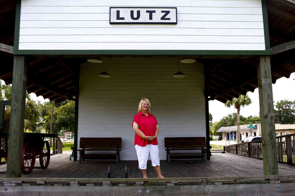 Faces of Florida's First and Main: Susan MacManus lives in her family's home on a secluded plot of land near Lutz, Fla. MacManus, shown at the old train depot across from the public library, is a political scientist and local historian. Her family was among the first to develop land around here a century ago.