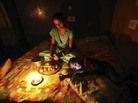 A girl prepares a meal by candlelight in Jammu, India, during the massive blackout last week. A girl prepares a meal by candlelight in Jammu, India, during the massive blackout last week.