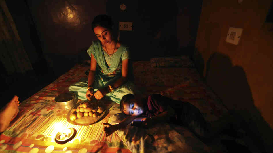 A girl prepares a meal by candlelight in Jammu, India, during the massive blackout last week.