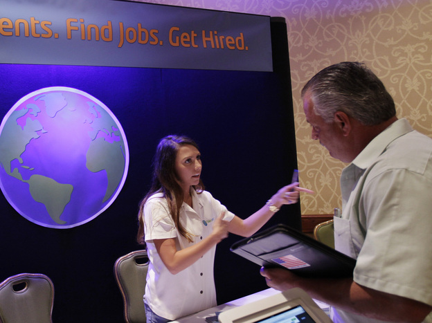 A job recruiter talks with an unemployed man, at a job fair in San Jose, Calif., last week. The Labor Department reported Friday that employers added 163,000 net jobs last month but the unemployment rate rose to 8.3 percent.