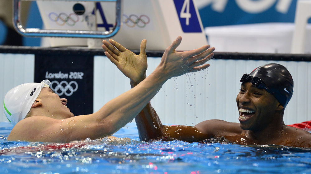 U.S. swimmer Cullen Jones (right) won the silver medal in the 50m freestyle. Here, he shakes hands with Brazil's Cesar Cielo after a semifinal heat.