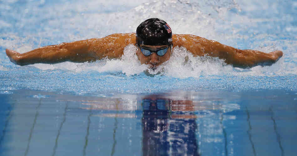 Michael Phelps competes in the men's 100m butterfly final. Phelps surged from behind to win the event. 