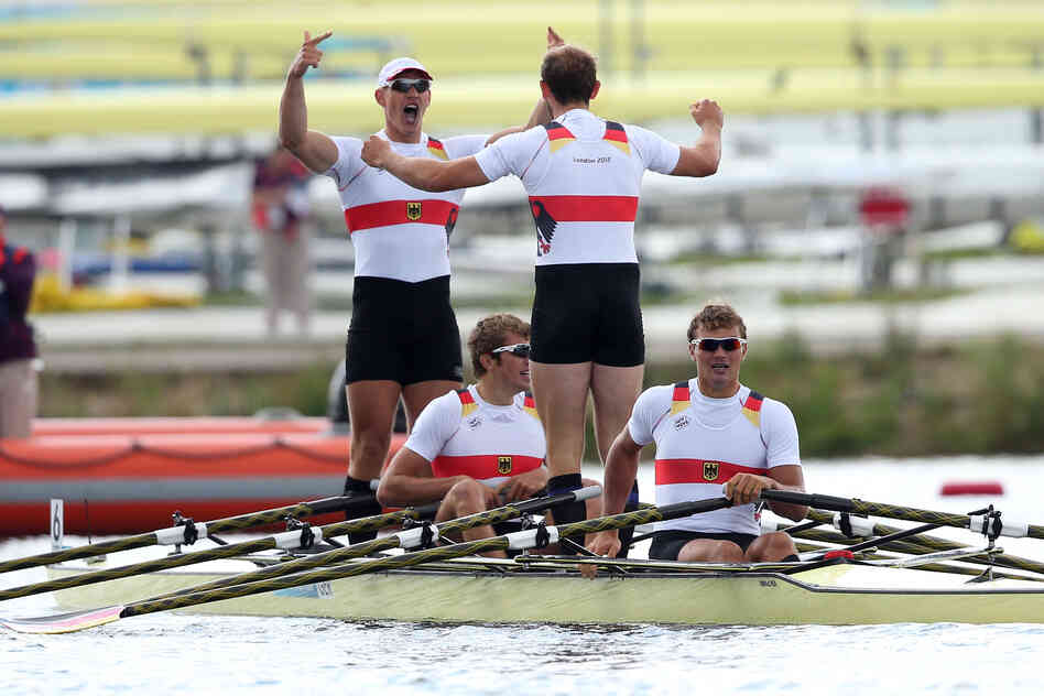 Karl Schulze, Phillipp Wende, Lauritz Schoof and Tim Grohmann of Germany celebrate winning gold in the men's quadruple sculls final.