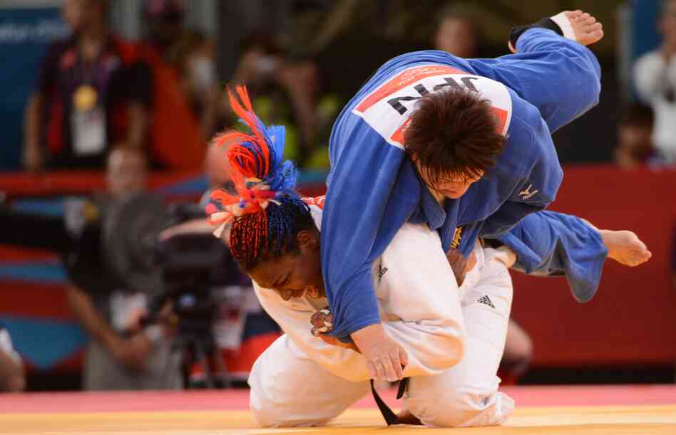 Cuba's Idalys Ortiz (in white) tosses Japan's Mika Sugimoto during the women's 78kg judo contest match. Ortiz won the match.