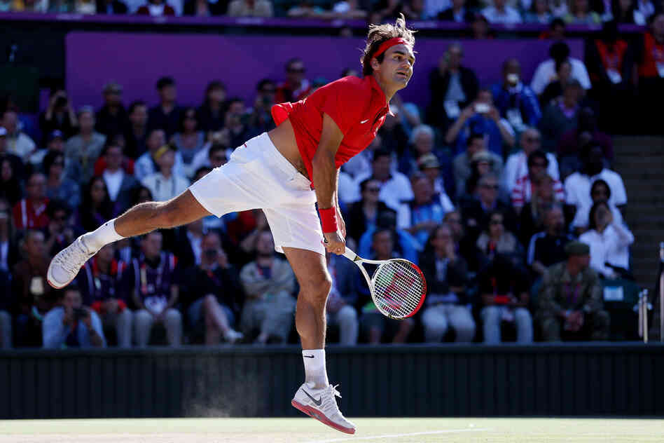 Roger Federer of Switzerland returns a shot in the third set against Juan Martin Del Potro of Argentina in the semifinal of men's singles tennis. Federer won the match, which took more than 4 hours to play.