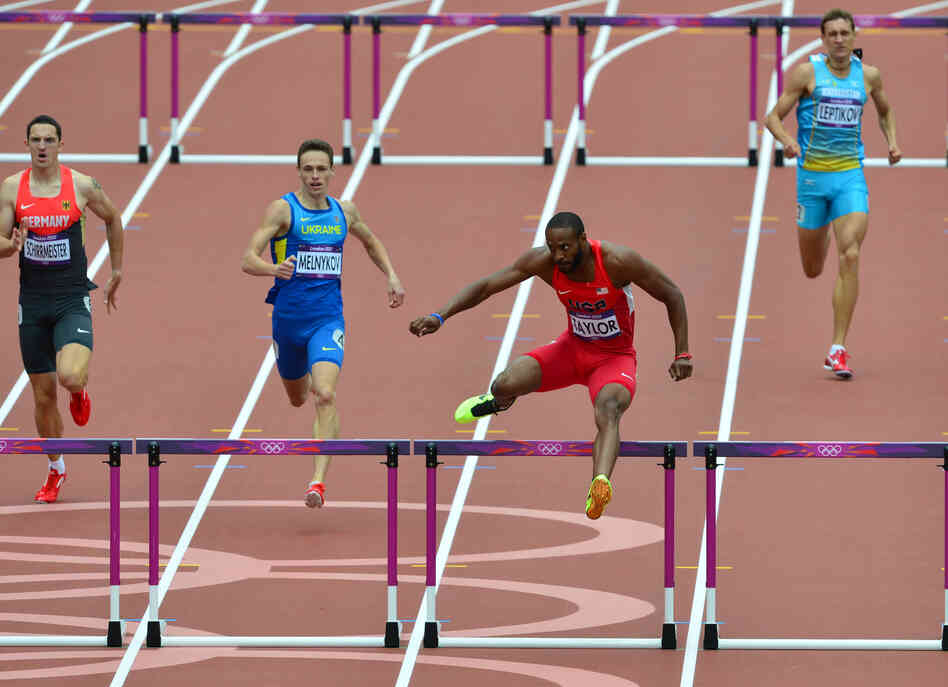 U.S. hurlders Angelo Taylor (second from right) competes in the men's 400m hurdles. He finished first in the heat. Today marks the first day of track and field events.