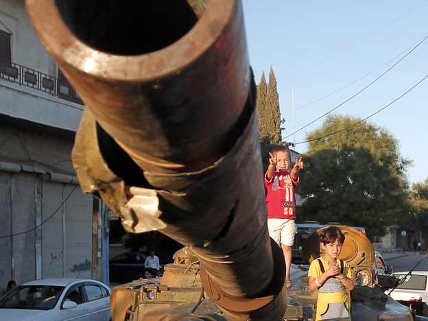 In Aleppo, Syria, on Thursday: Children climb on an abandoned Syrian army tank. (AFP/Getty Images)