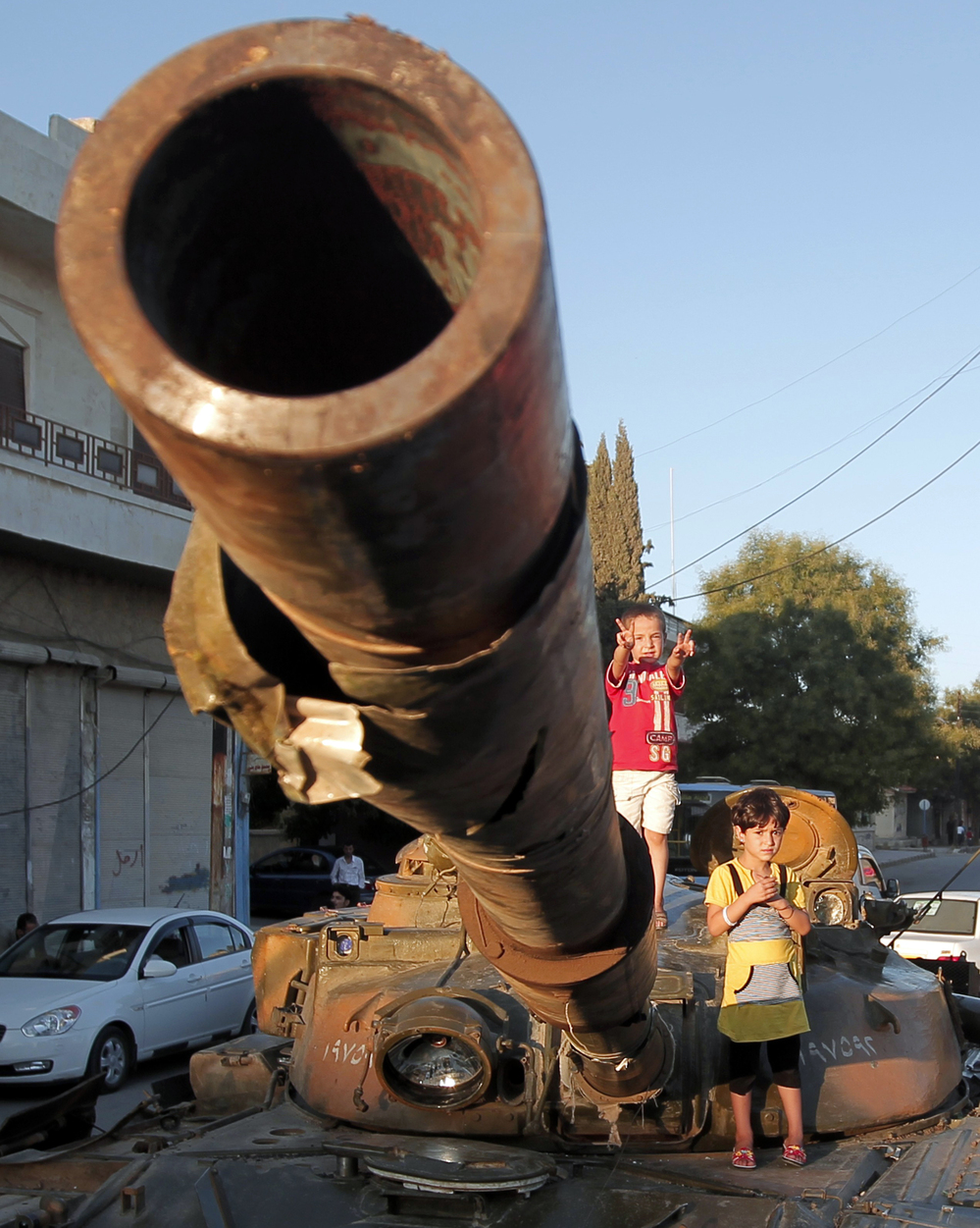 In Aleppo, Syria, on Thursday: Children climb on an abandoned Syrian army tank.