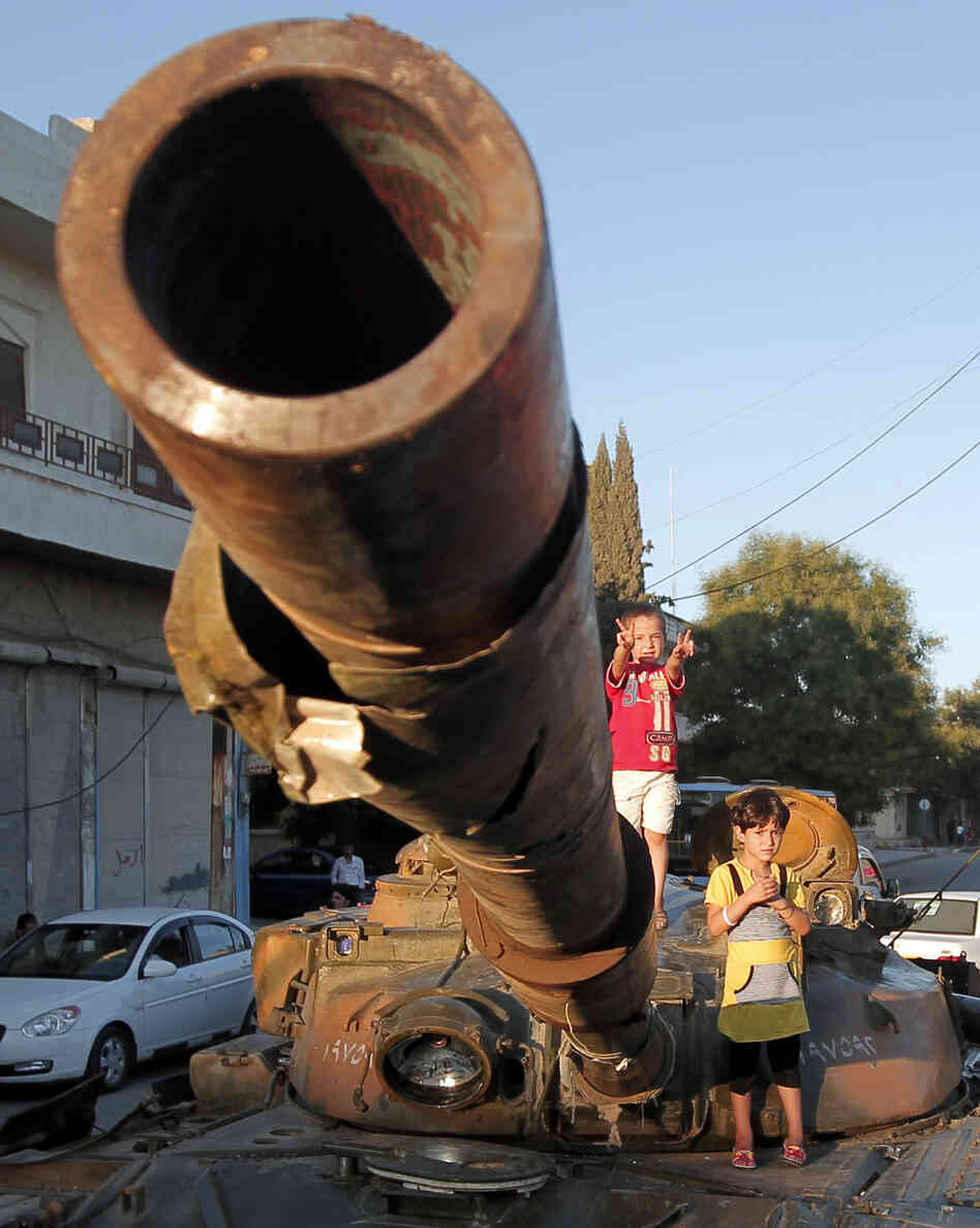 In Aleppo, Syria, on Thursday: Children climb on an abandoned Syrian army tank.