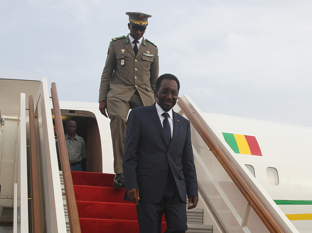 Mali's interim president, Dioncounda Traore, disembarks from a plane at Bamako airport last month. Traore returned to Bamako amid tight security following a two-month stay in Paris for medical treatment after being savagely beaten in the aftermath of the country's coup.