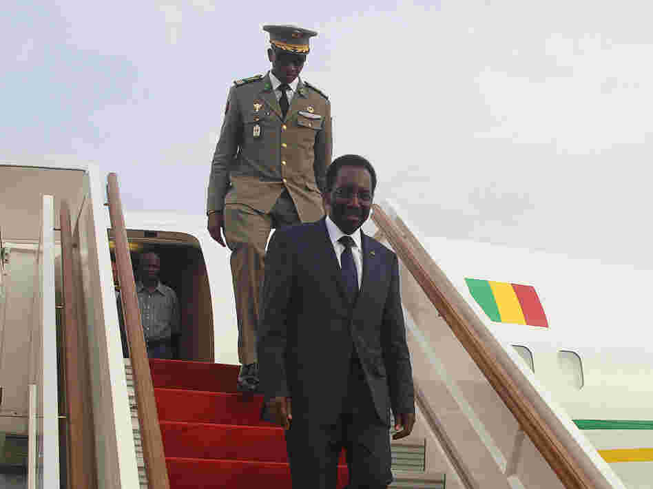 Mali's interim president, Dioncounda Traore, disembarks from a plane at Bamako airport last month. Traore returned to Bamako amid tight security following a two-month stay in Paris for medical treatment after being savagely beaten in the aftermath of the country's coup.