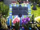 Fans leave all manner of mementos at Andy Warhol's grave site, near Pittsburgh. This spring, a local Warhol impersonator wrapped the grave stone in colorful paper for an entire month. Fans leave all manner of mementos at Andy Warhol's grave site, near Pittsburgh. This spring, a local Warhol impersonator wrapped the grave stone in colorful paper for an entire month.
