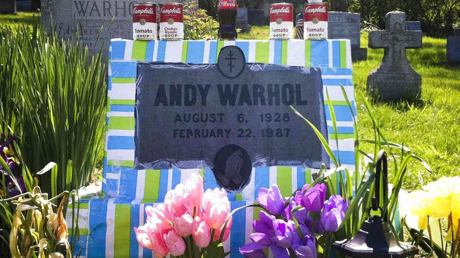 Fans leave all manner of mementos at Andy Warhol's grave site, near Pittsburgh. This spring, a local Warhol impersonator wrapped the grave stone in colorful paper for an entire month.