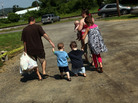 Members of the Dolan family walk home with bags of food from the Southern Tier Mobile Food Pantry in Oswego, N.Y., in June. Food banks across the nation are reporting giant spikes in demand. Members of the Dolan family walk home with bags of food from the Southern Tier Mobile Food Pantry in Oswego, N.Y., in June. Food banks across the nation are reporting giant spikes in demand.