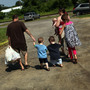 Members of the Dolan family walk home with bags of food from the Southern Tier Mobile Food Pantry in Oswego, N.Y., in June. Food banks across the nation are reporting giant spikes in demand.
