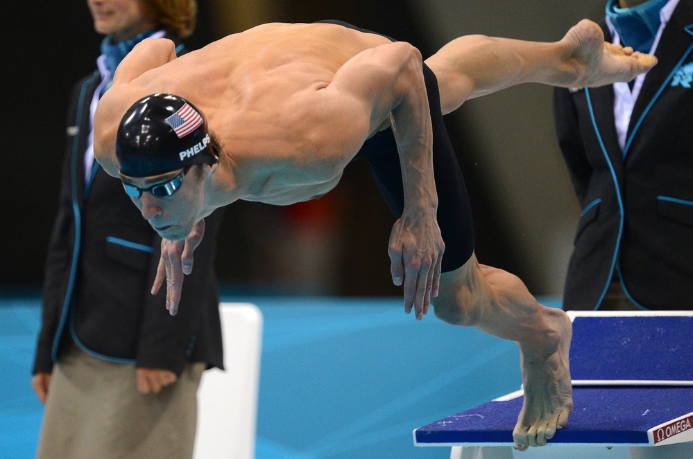 One more time: American swimmer Michael Phelps dives in to swim the butterfly leg of the men's medley relay Saturday. Phelps' team won the Olympic gold medal, giving him 22 overall and 18 gold when he leaves the London Games.