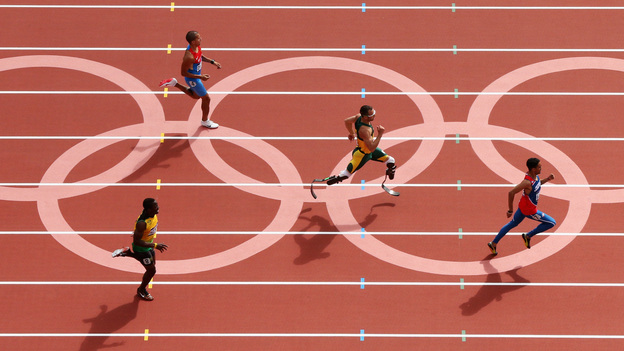 Oscar Pistorius of South Africa, center, became the first amputee to run in the Olympics. He came in second to Luguelin Santos of the Dominican Republic, to advance to the men's 400m semifinals.