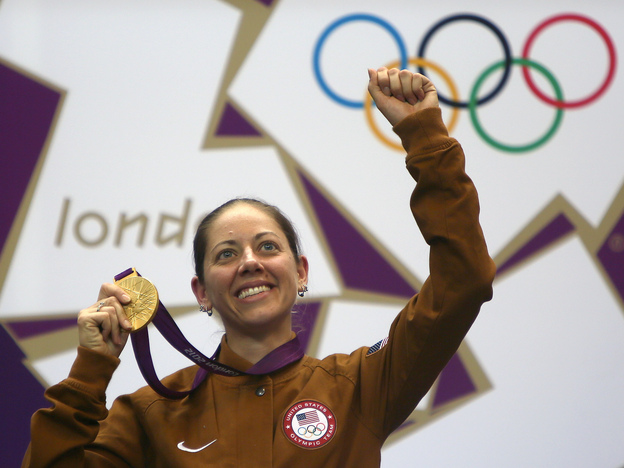 American gold medalist Jamie Lynn Gray celebrates on the podium after winning the 50m rifle 3 positions women final at the Royal Artillery Barracks in London.
