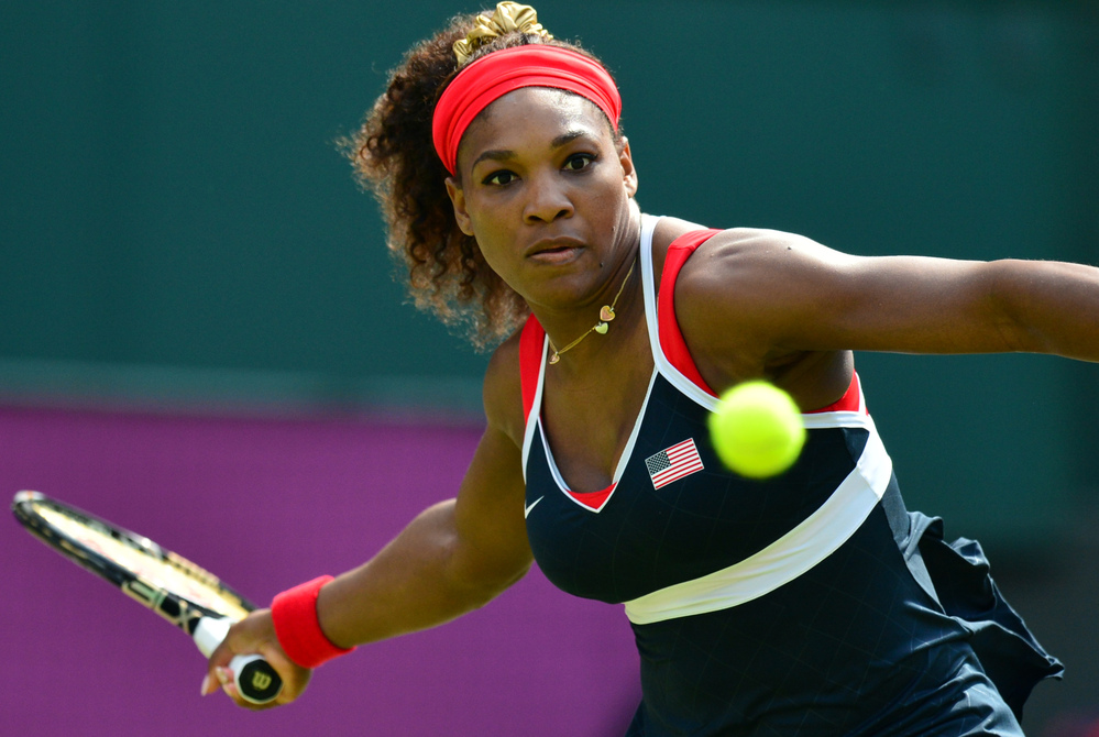 Serena Williams hits a return to Russia's Maria Sharapova during their final tennis match in the 2012 London Olympic Games at the All England Tennis Club in Wimbledon. Williams won, 6-0, 6-1.