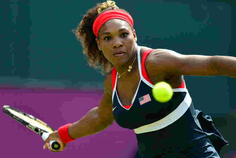 Serena Williams hits a return to Russia's Maria Sharapova during their final tennis match in the 2012 London Olympic Games at the All England Tennis Club in Wimbledon. Williams won, 6-0, 6-1.